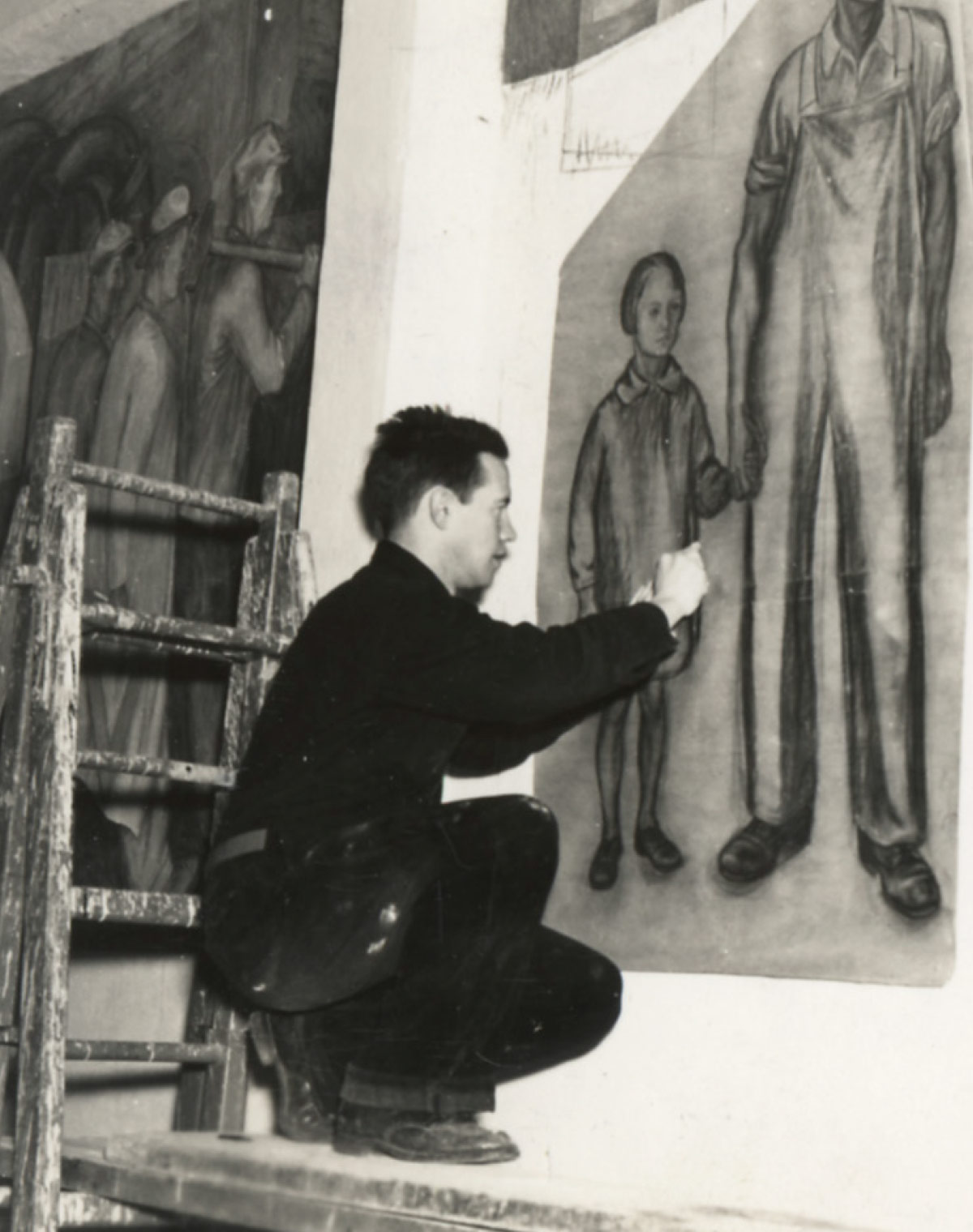 James Egelson standing on scaffolding and painting frescoes on the wall