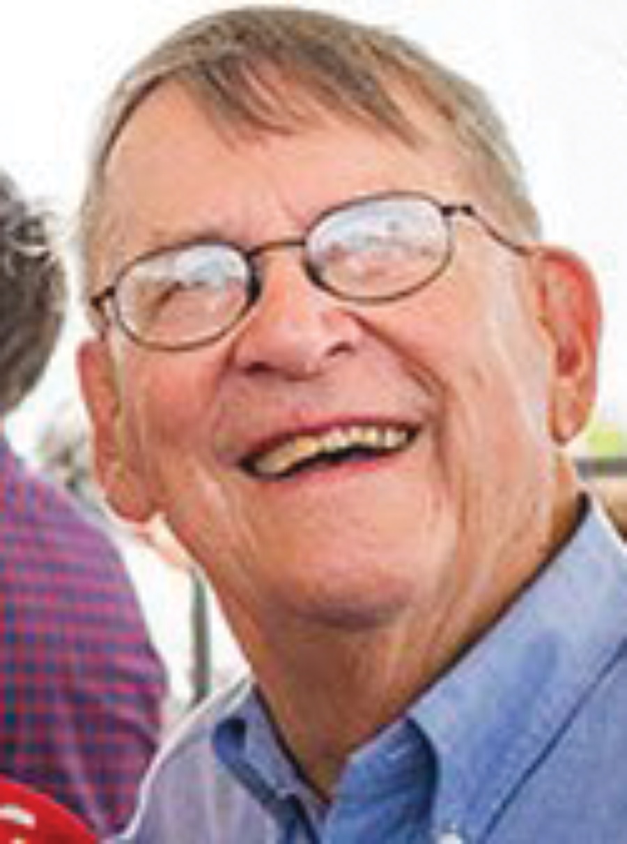 Headshot of Pete Thompson, smiling, looking up, and wearing glasses.