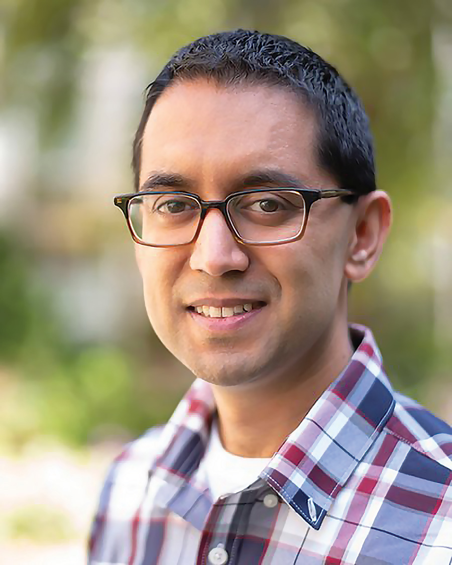 Headshot of Ameet Soni. He is wearing glasses and a red and blue plaid button-down shirt.