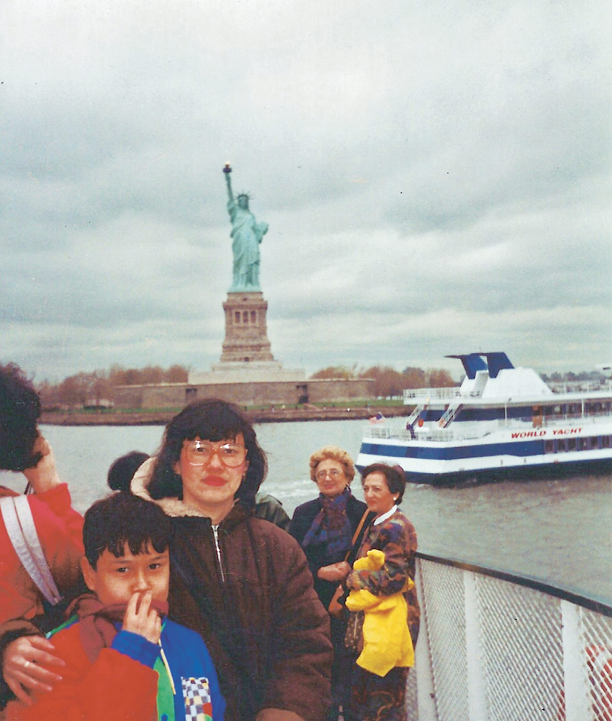 Childhood photo of Jorge Aguilar and his mother Denia Ching posing with the Statue of Liberty in the background