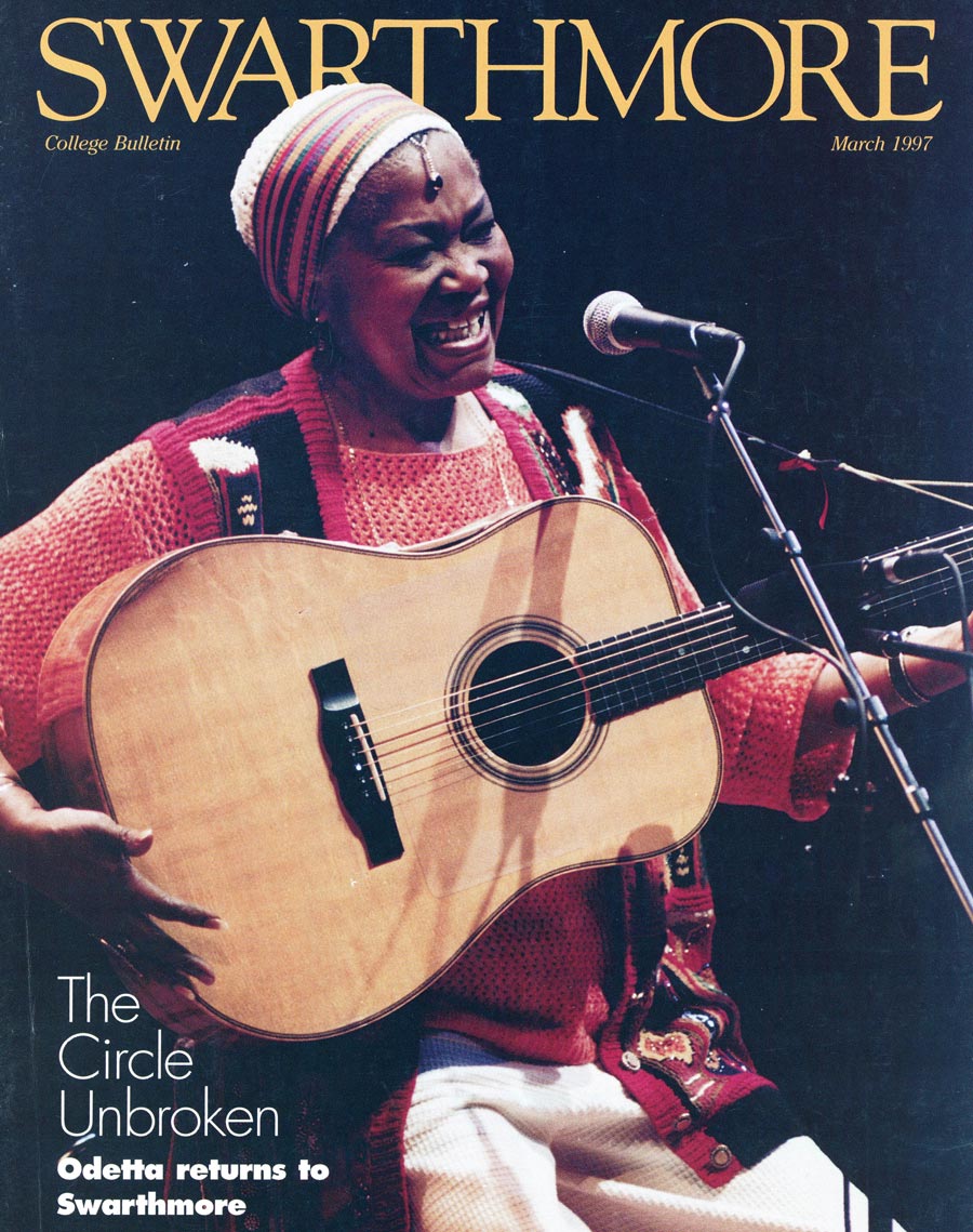 Odetta wearing an orange sweater, knit hat, playing a guitar Odetta on the cover of the Swarthmore College Bulletin's March 1997 issue.