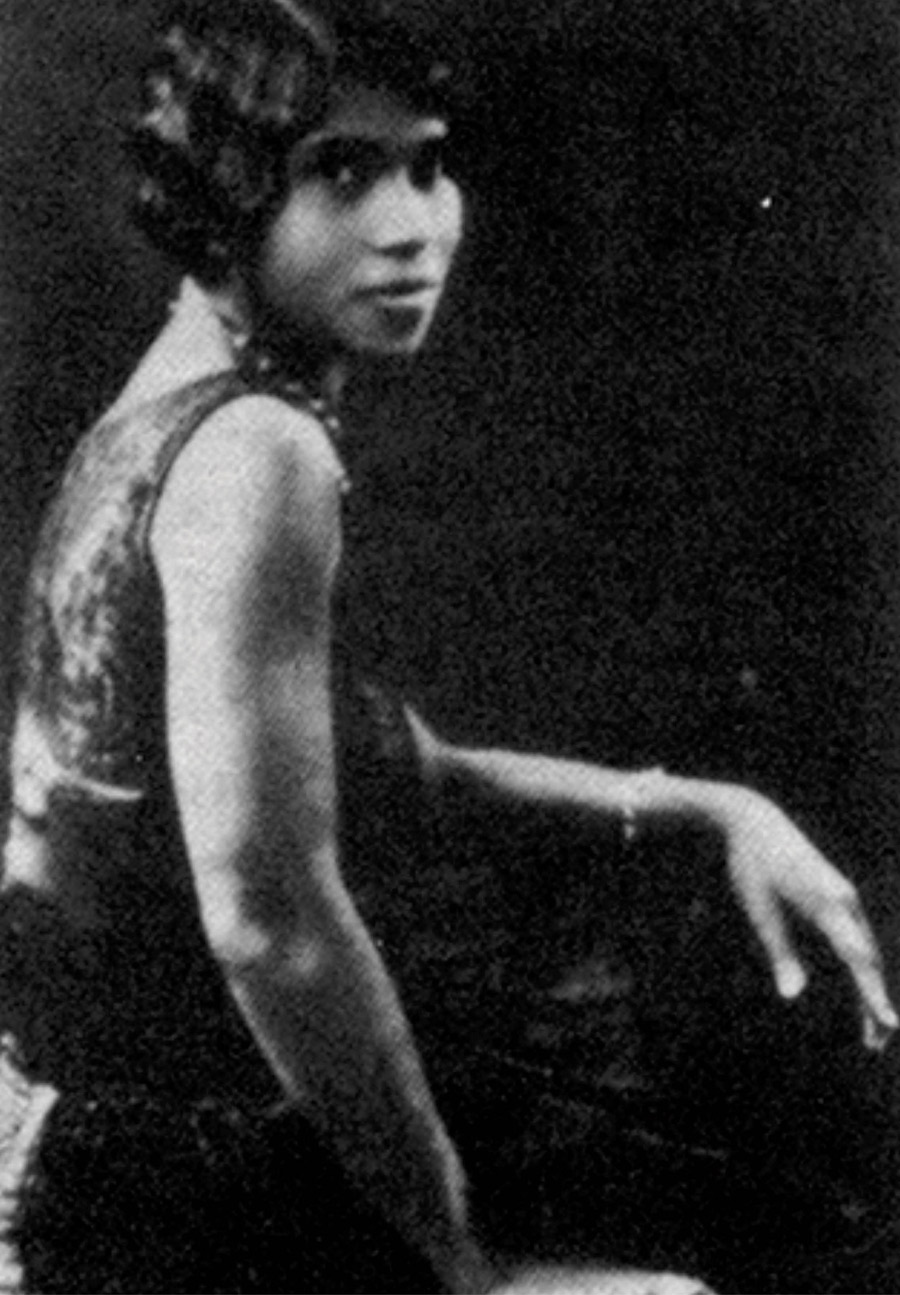 Medium long shot of Marian Anderson, seated, in black and white.
