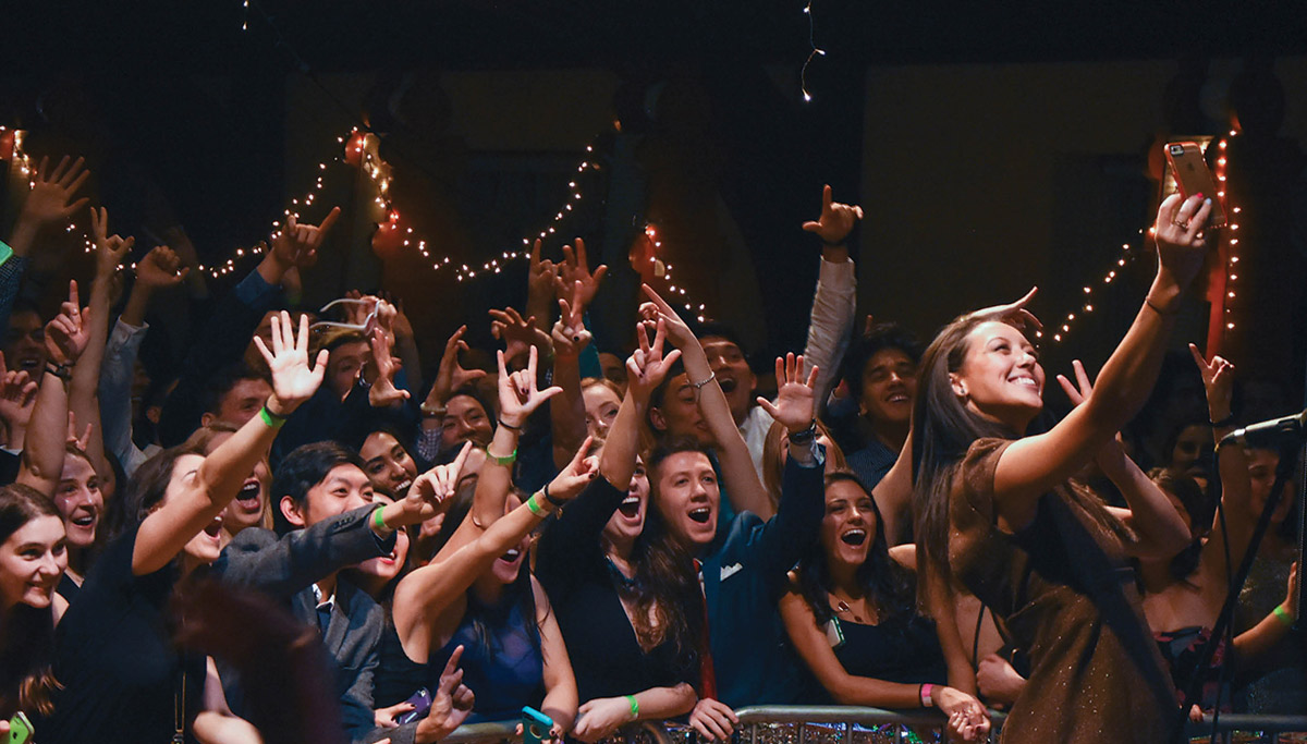 performer on stage taking a selfie with the audience