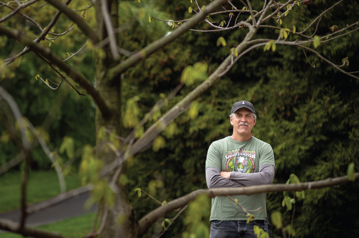Lars Rasmussen, photographed through tree branches.