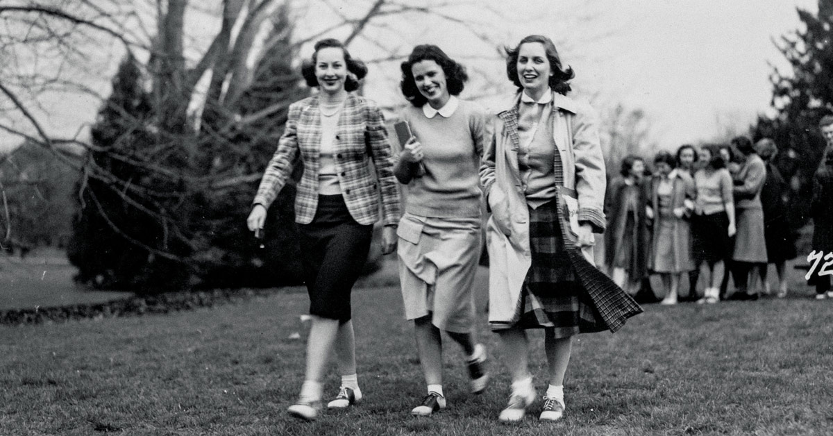 Black and white photo of Lucy and her friends walking across campus, circa 1940.