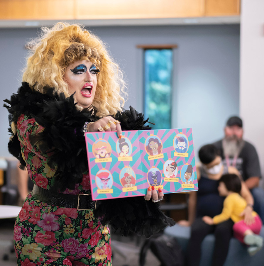 Lil Miss Hot Mess '06 reads to children at Drag Story Hour.