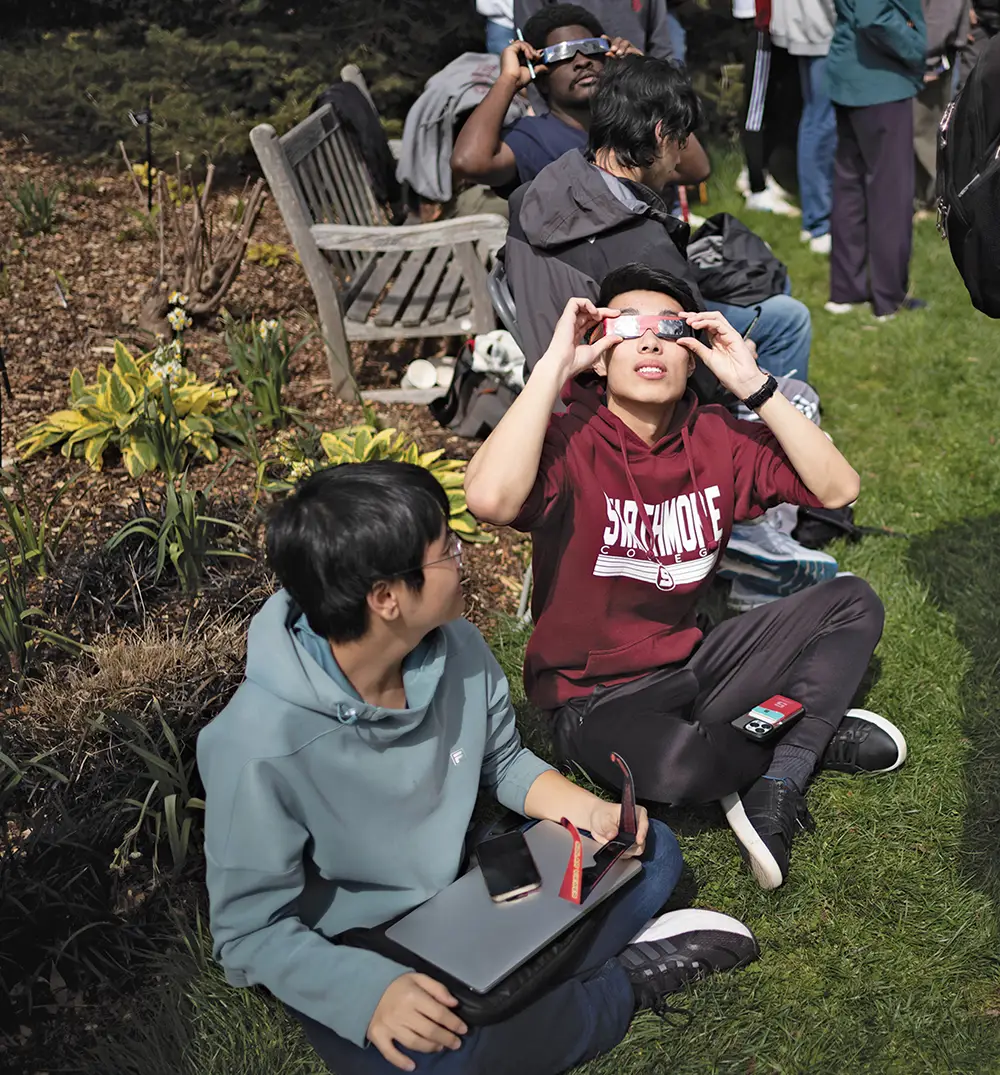 Students observe the eclipse through special glasses that protect their eyes.