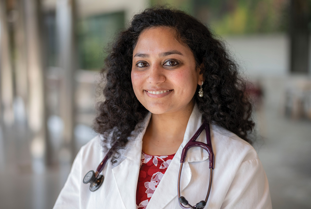 Head shot of Farah Hussain in her lab coat and stethoscope