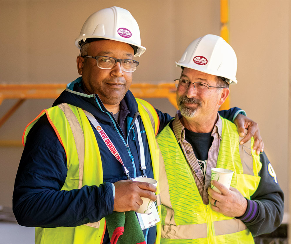 Parents pose in hard hats.