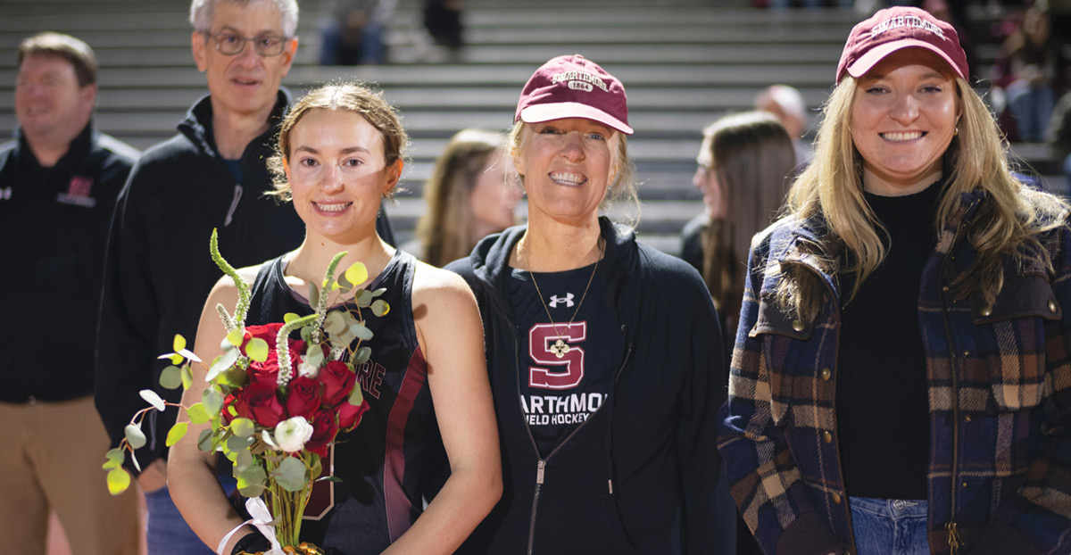 Field hockey player Katie Kohn poses with red roses in hand.