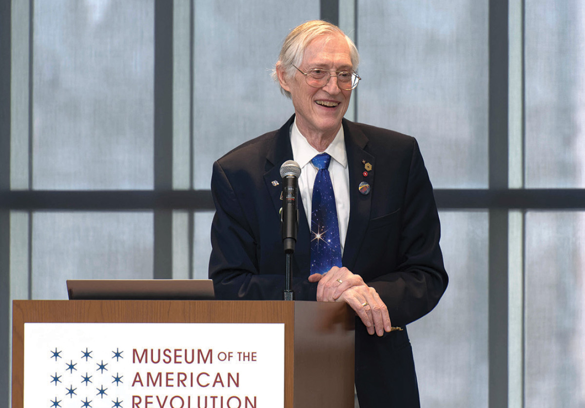 John Mather stands behind a podium at the Museum of the American Revolution.