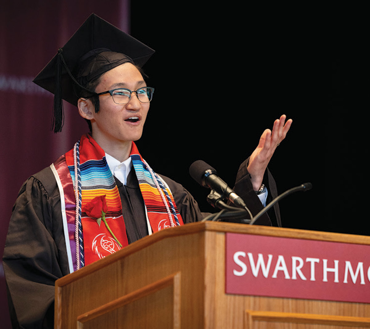 Graduating senior Drake Roth speaks to the Commencement audience from a podium.