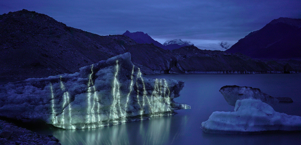 Lines of light projected onto a glacier at dusk