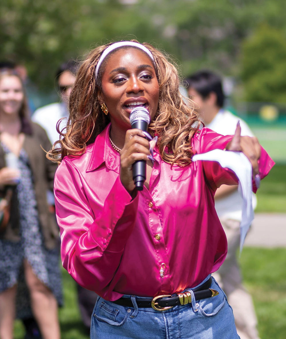 Osazenoriuwa Ebose '15 speaks into a microphone