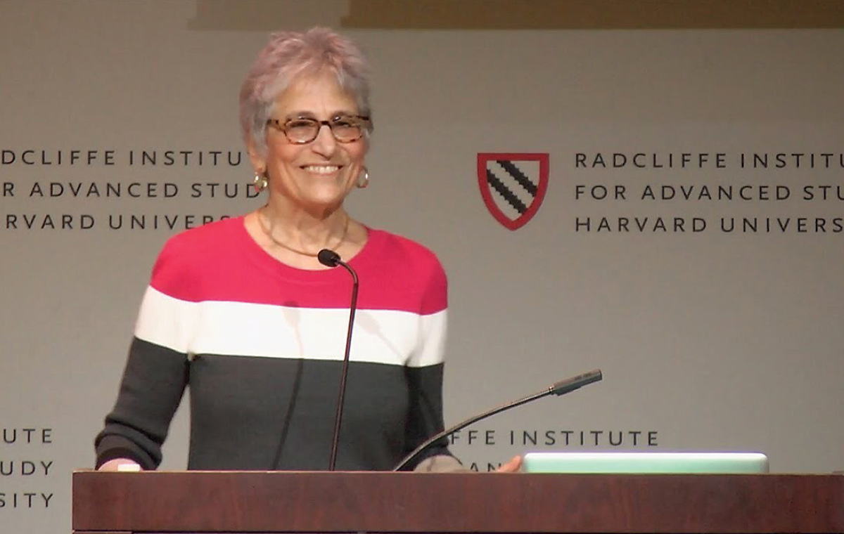 Linda Gordon '61 stands behind a podium at Harvard.