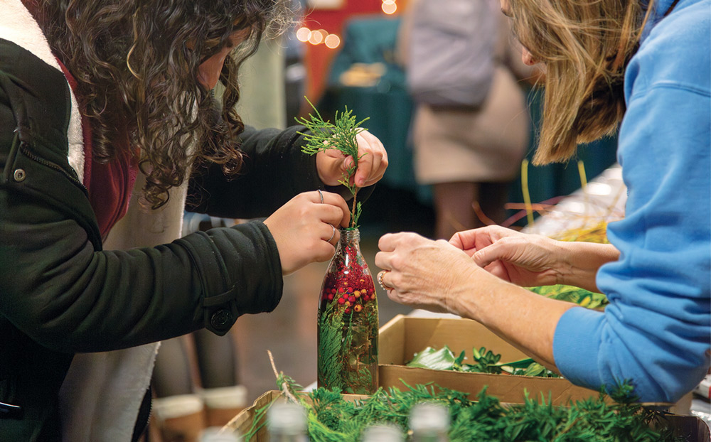 Students makes snowglobes with branches and berries found on campus.