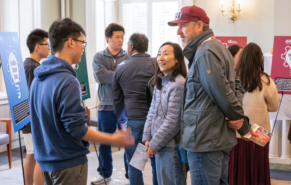 Students present their work to alumni.