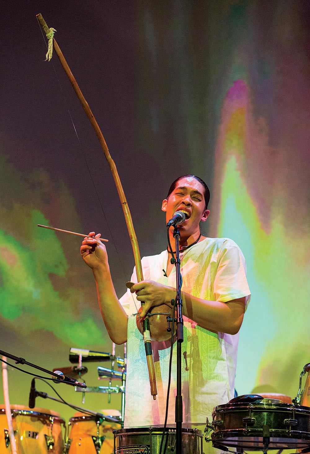 Alex Shaw '00 plays berimbau and sings on stage.