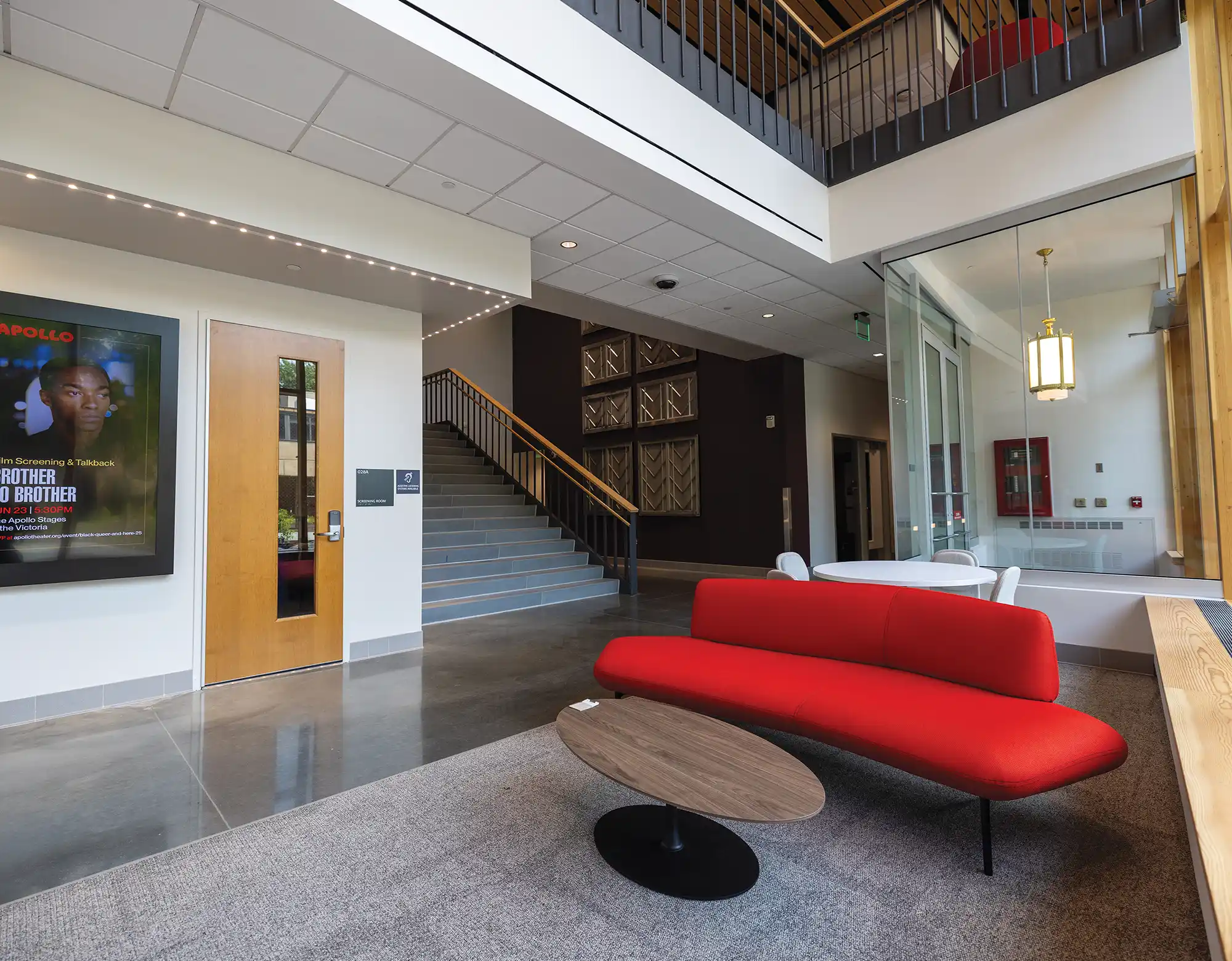 Door to a Martin Hall screening room; bright red seats in Martin Hall’s common area.