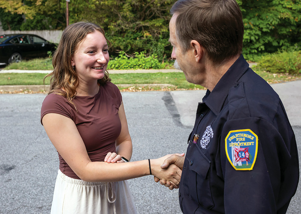 Cassandra Conklin '26 shakes hands with a firefighter.