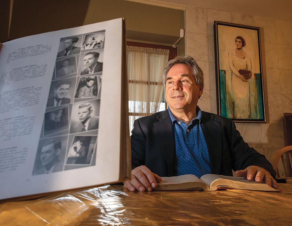 Matthew Hirsch looks through the Swarthmore yearbook of his late father, William Hirsch '49.