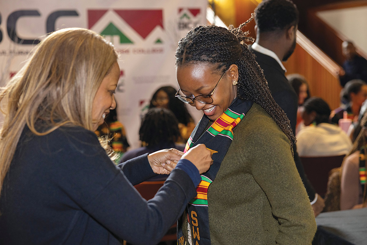 Nicole Odell Odim ’88 attaches a pin to Happy Hadia Ingabire ’26 at the annual Black Cultural Center awards luncheon.