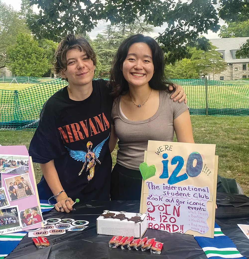 Eva Kermorgant '26 and Andrea Cheah '27 staff a table representing the international student organization i20.