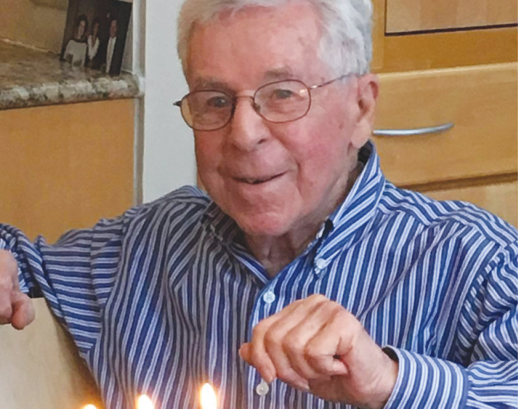 William "Bill" Hirsch '49 in a blue-and-white striped shirt.