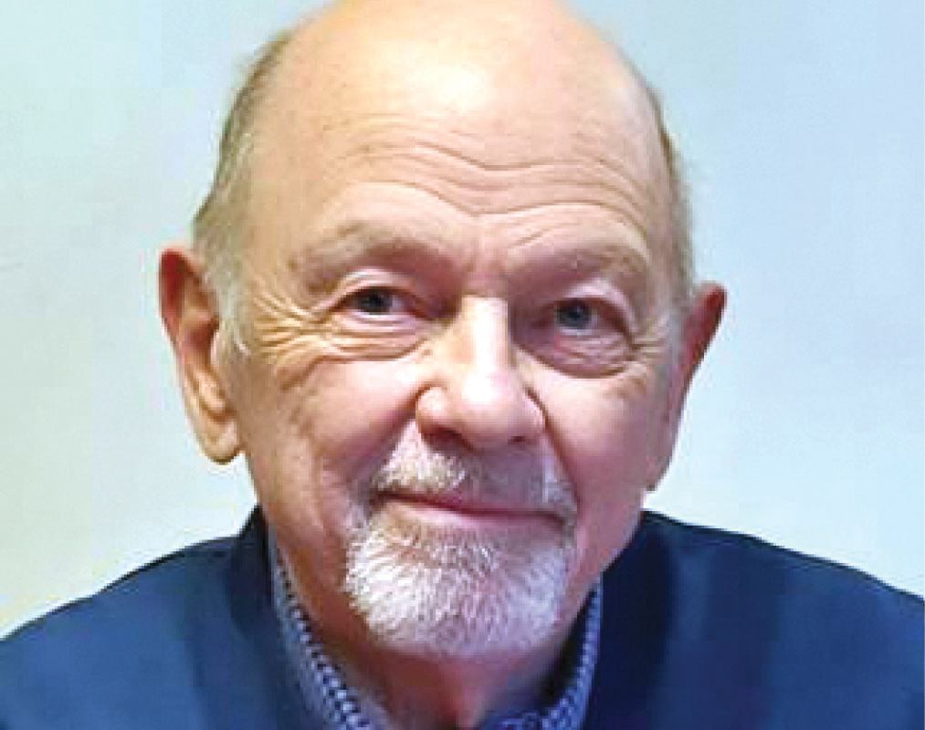 Peter Van Pelt '54 in a blue sweater.