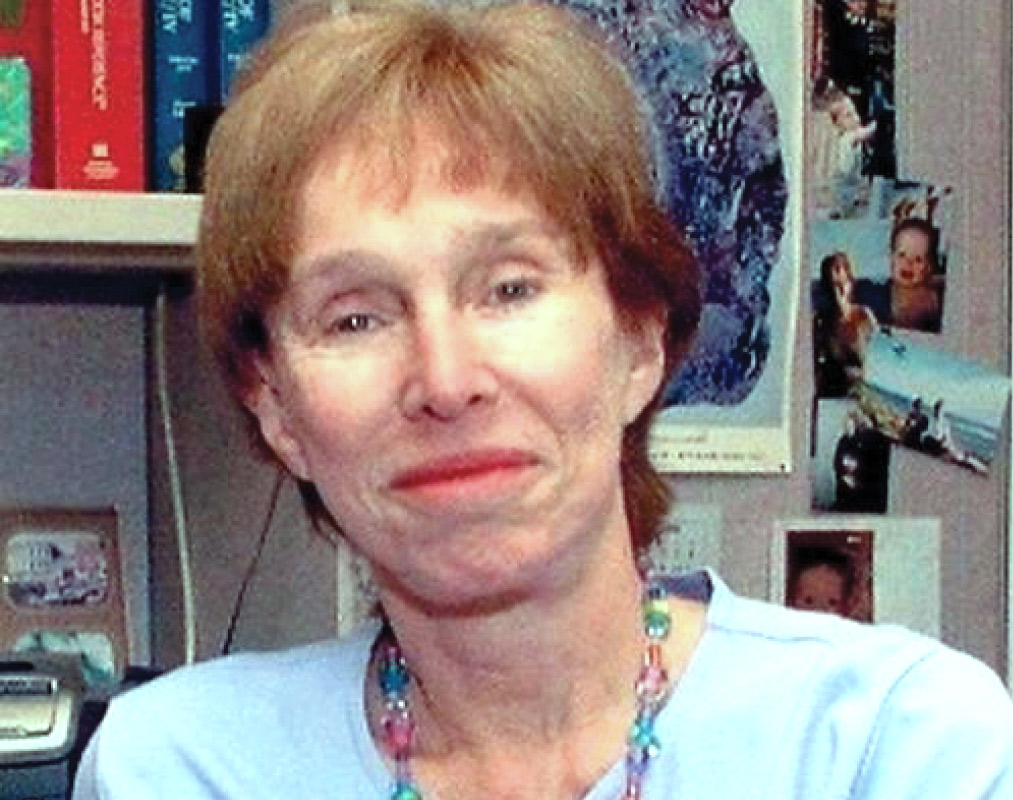Judith "Judy" Livant Rapoport '55 wears a colorful necklace and a blue shirt.