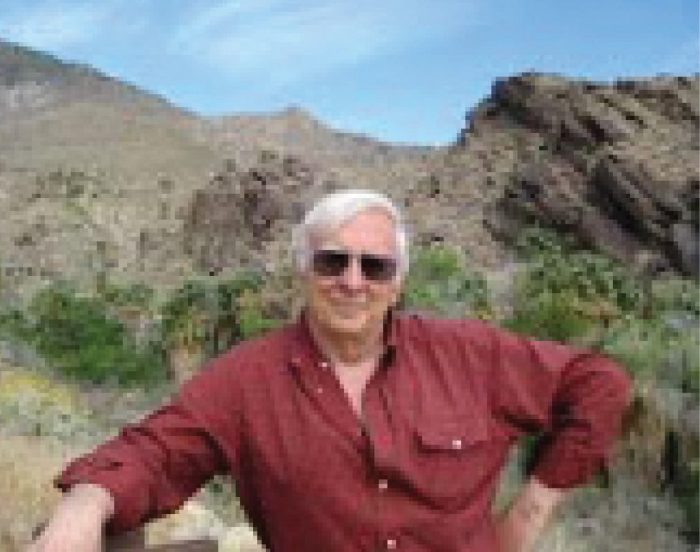 Jeffrey "Jeff" R. Davidson '58 in the mountains in a red button-down shirt.