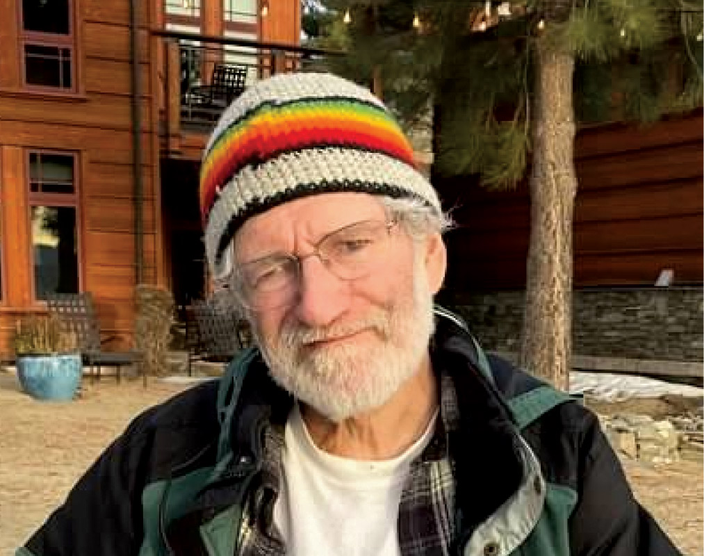 Eric G. Gaal '77 wears a knit hat with a rainbow pattern.