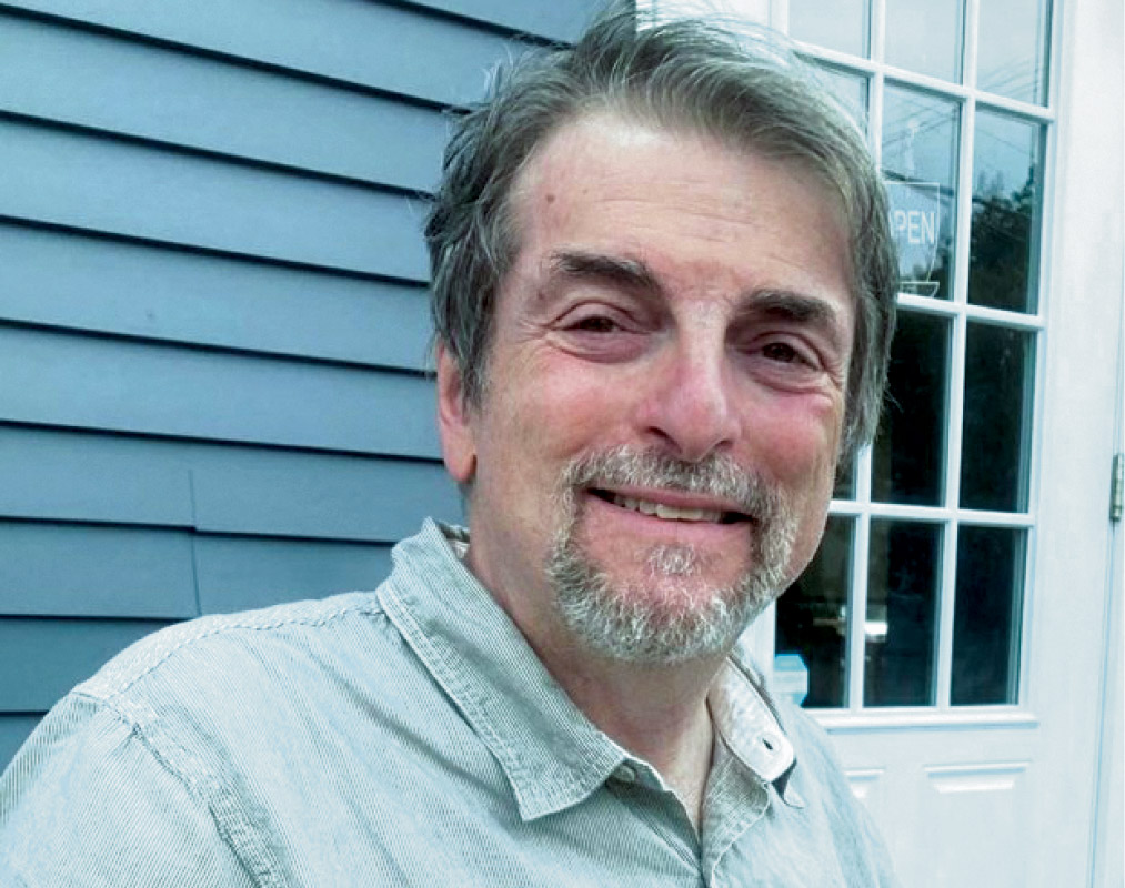 Jason P. Greenberg '82 stands in front of a window.