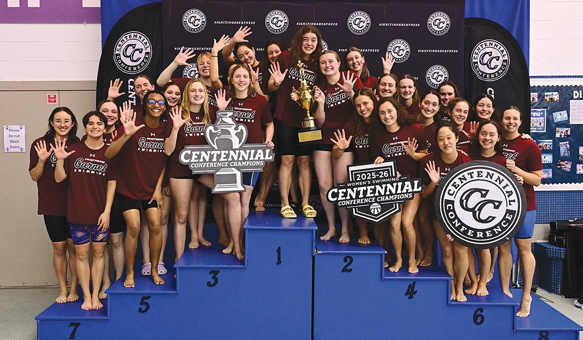 The women's swimming team poses with their Centennial Conference trophy.