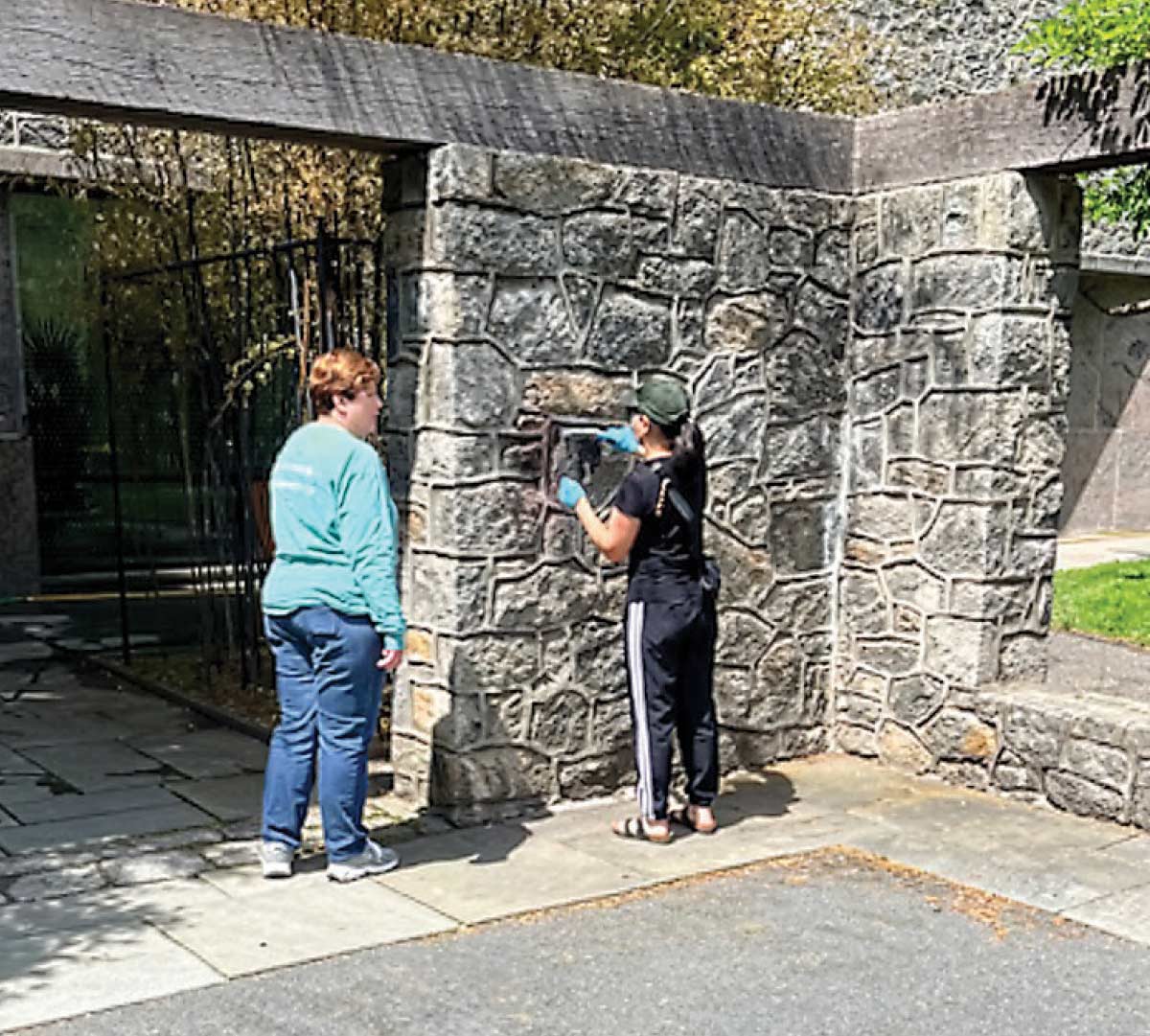 Community members cleaning up graffiti on campus.